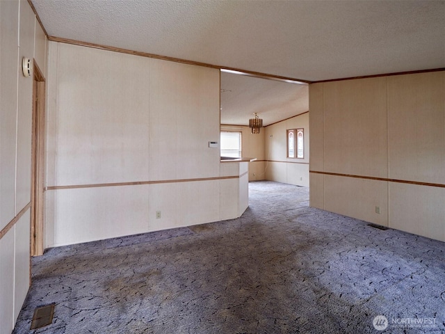 1850 Heartwood Dr, Woodland, WA 98674 - carpeted spare room with lofted ceiling, a textured ceiling, visible vents, and a chandelier
