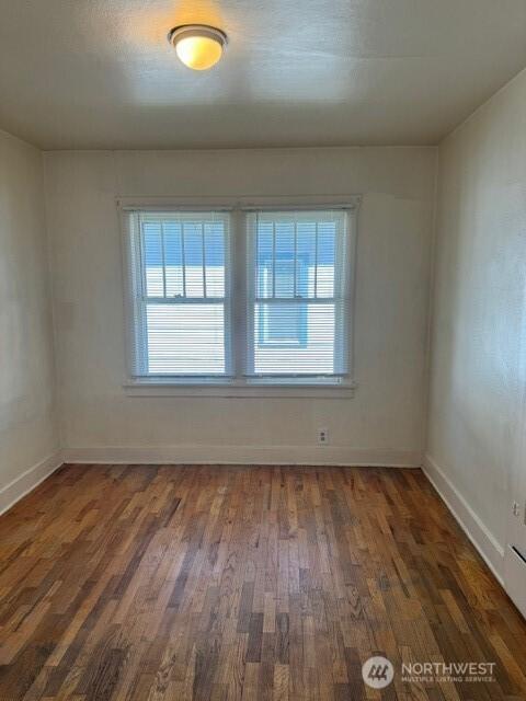 609 S 16th Ave, Yakima, WA 98902 - empty room with wood finished floors and baseboards