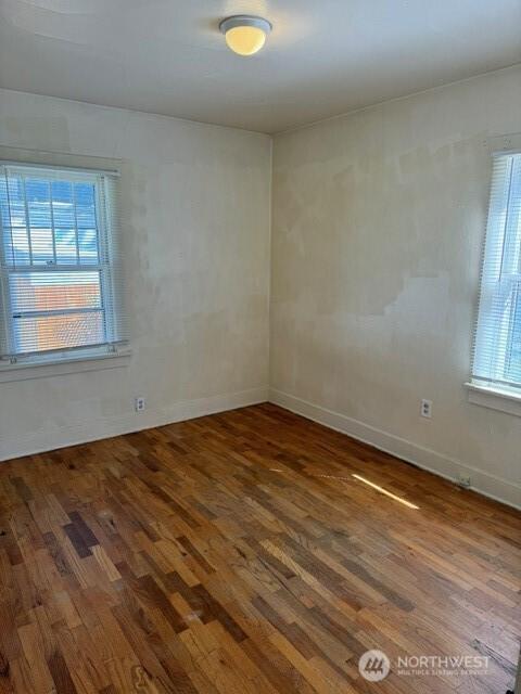 609 S 16th Ave, Yakima, WA 98902 - empty room with baseboards, a wealth of natural light, and wood finished floors