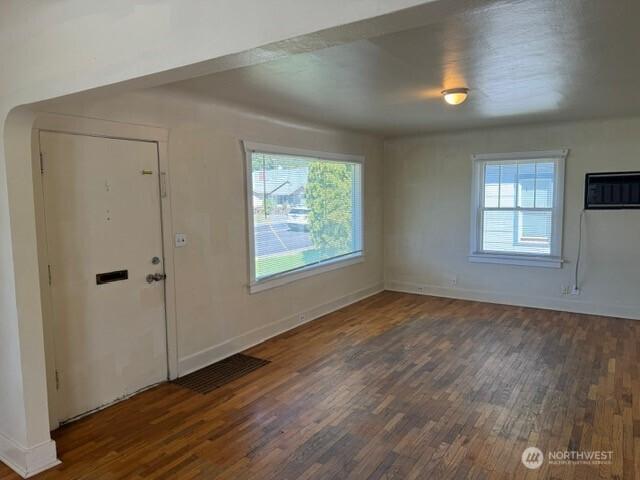 609 S 16th Ave, Yakima, WA 98902 - foyer featuring visible vents, wood finished floors, baseboards, and a wall mounted AC