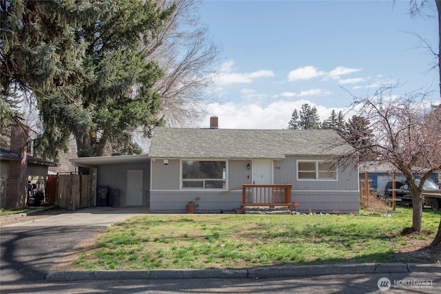 708 S Park Pl, Ellensburg, WA 98926 - view of front of property with fence, a chimney, concrete driveway, a front lawn, and a carport