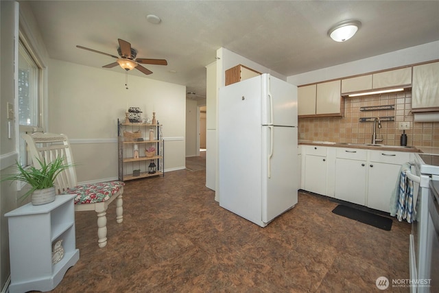 708 S Park Pl, Ellensburg, WA 98926 - kitchen featuring dark floors, white appliances, a ceiling fan, tasteful backsplash, and a sink