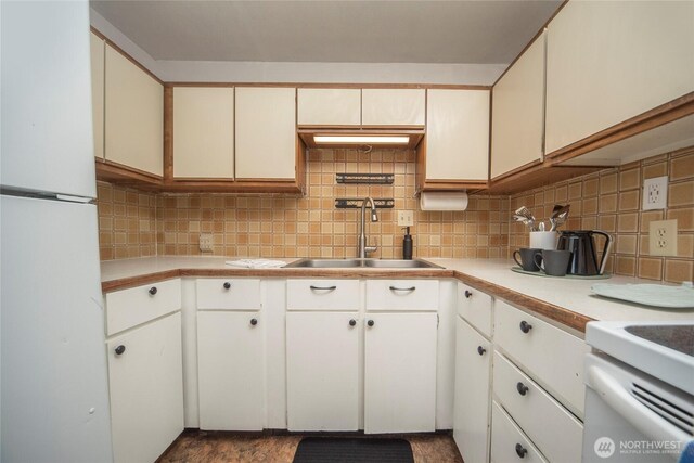708 S Park Pl, Ellensburg, WA 98926 - kitchen featuring freestanding refrigerator, light countertops, a sink, and tasteful backsplash