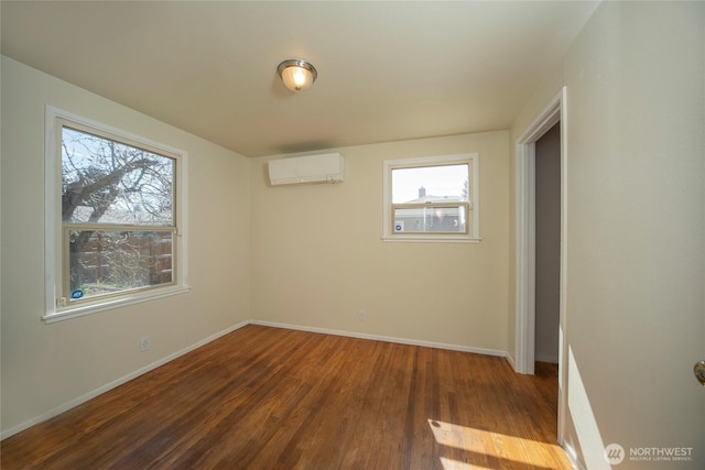708 S Park Pl, Ellensburg, WA 98926 - unfurnished room featuring a wall unit AC, baseboards, and wood finished floors