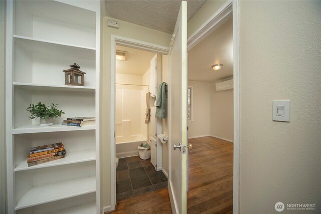 708 S Park Pl, Ellensburg, WA 98926 - hallway featuring dark wood-type flooring, baseboards, and a textured ceiling