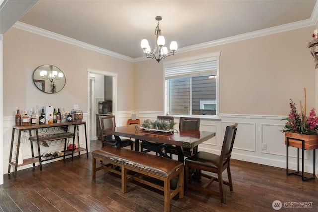 dining room featuring a notable chandelier, dark wood-style floors, and crown molding