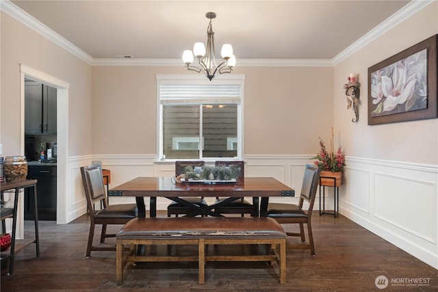dining room featuring dark wood finished floors, visible vents, crown molding, and an inviting chandelier