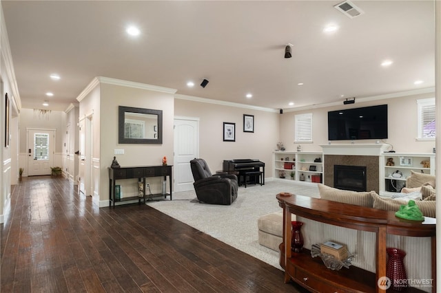 living room featuring dark wood-style floors, visible vents, recessed lighting, and ornamental molding