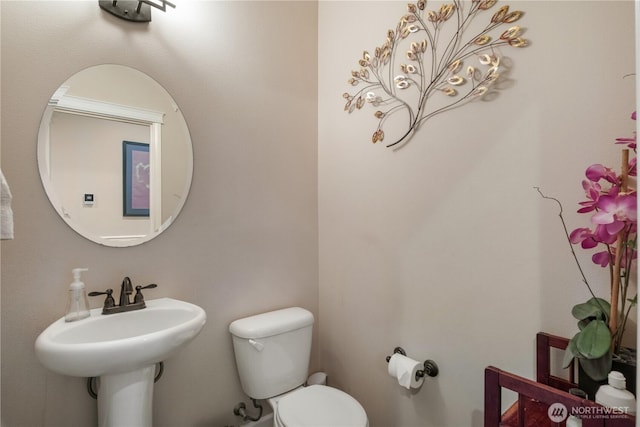 half bathroom featuring toilet