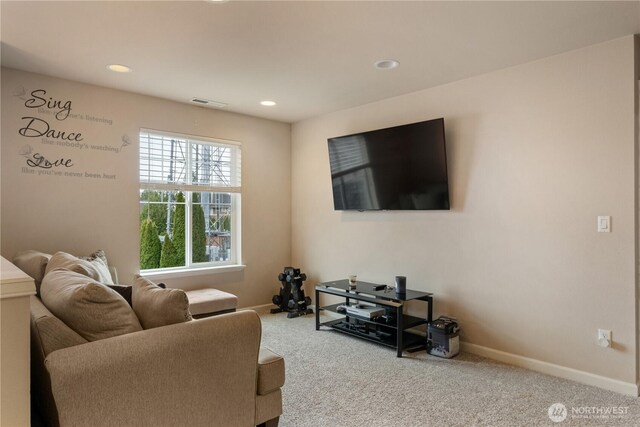 carpeted living area featuring baseboards, visible vents, and recessed lighting