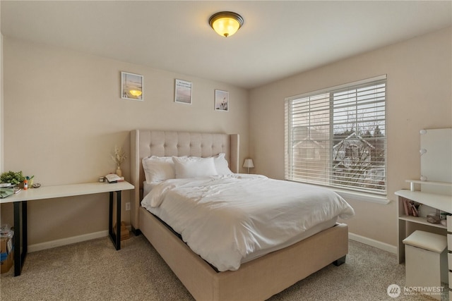 bedroom with baseboards and light colored carpet