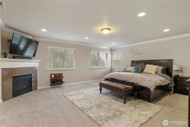 bedroom with carpet floors, a glass covered fireplace, baseboards, visible vents, and ornamental molding