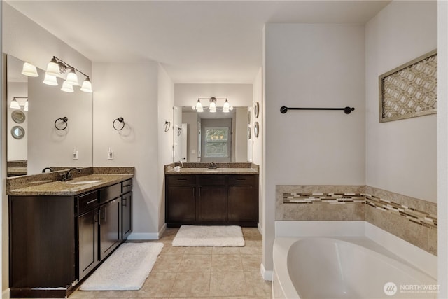 bathroom featuring tile patterned floors, a sink, two vanities, and a garden tub