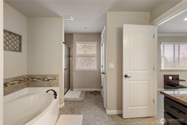 full bath featuring a bath, vanity, tile patterned flooring, and a shower stall