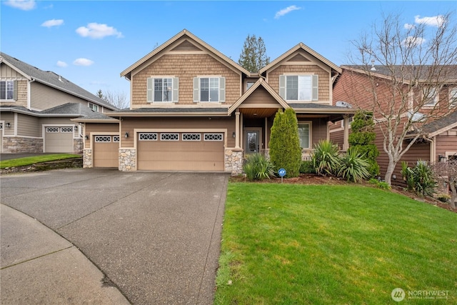 craftsman-style house with driveway, a garage, stone siding, and a front yard