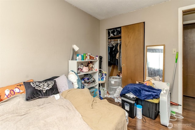 bedroom with a closet and wood finished floors