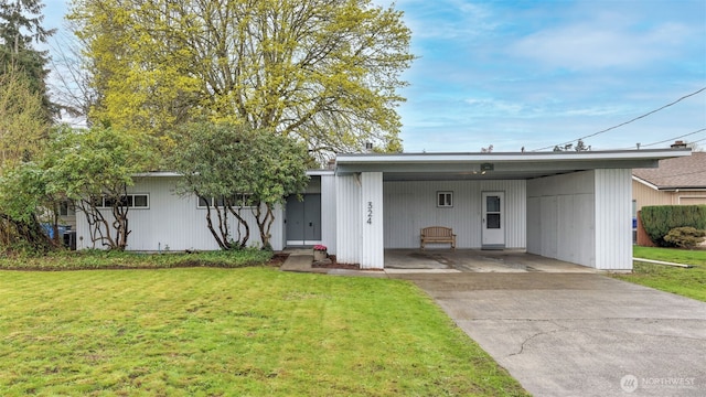 view of front of house with an attached carport, driveway, and a front lawn
