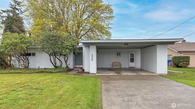 view of front facade with driveway, a front yard, and a carport