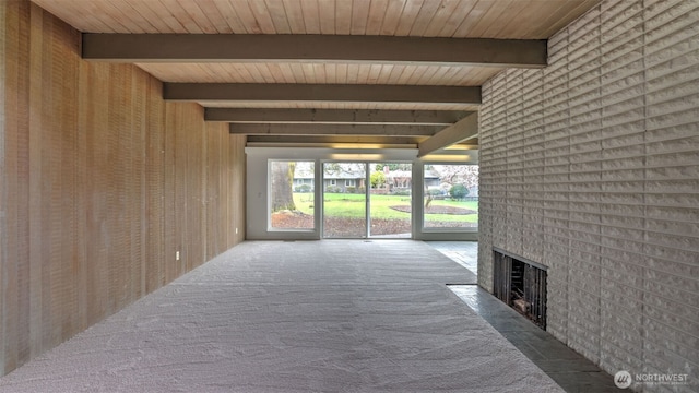 hall featuring wood ceiling, carpet floors, and beam ceiling