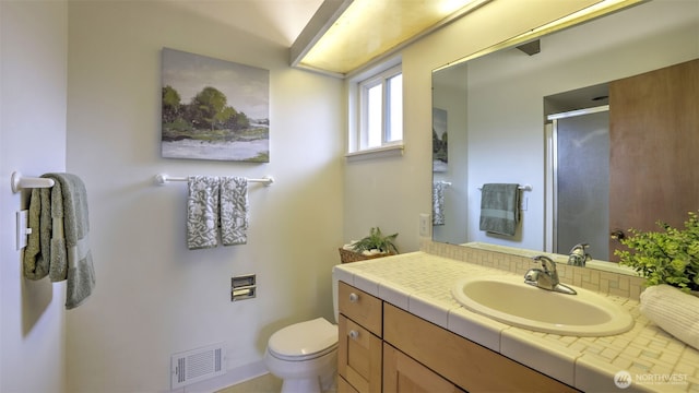 bathroom featuring a stall shower, visible vents, toilet, and vanity