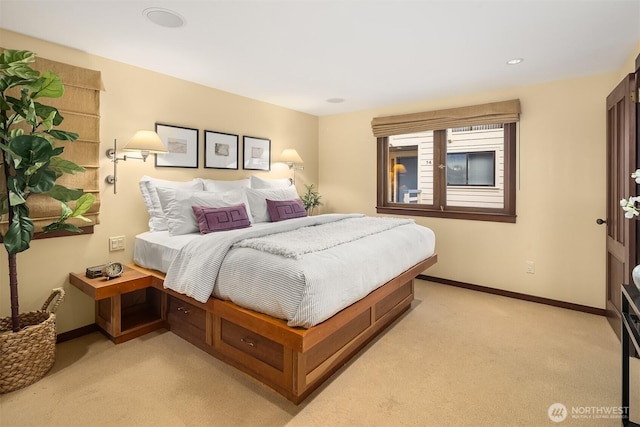 bedroom featuring baseboards and light colored carpet
