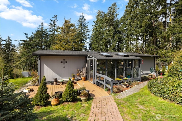 rear view of property featuring a deck