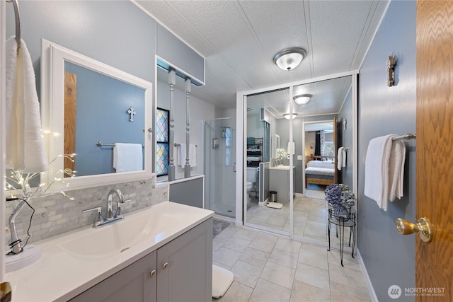 ensuite bathroom with a textured ceiling, a shower stall, connected bathroom, toilet, and backsplash