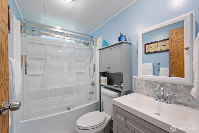 bathroom with a textured ceiling, combined bath / shower with glass door, toilet, vanity, and backsplash