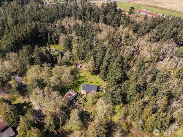 drone / aerial view featuring a forest view