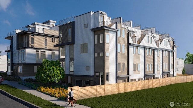 view of building exterior with a residential view and fence
