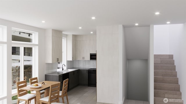 kitchen with a sink, modern cabinets, recessed lighting, and range