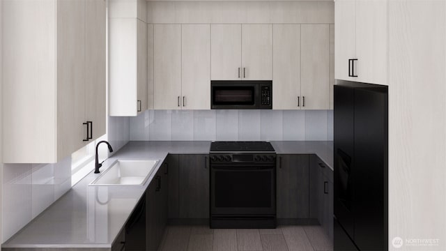 kitchen with a sink, backsplash, black appliances, and light countertops
