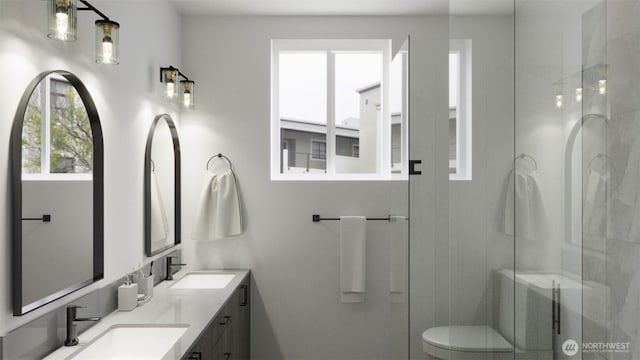bathroom with double vanity, toilet, a shower stall, and a sink