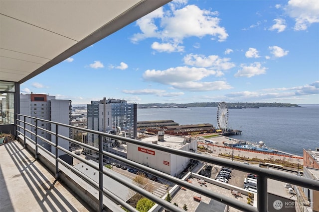 balcony with a water view and a city view