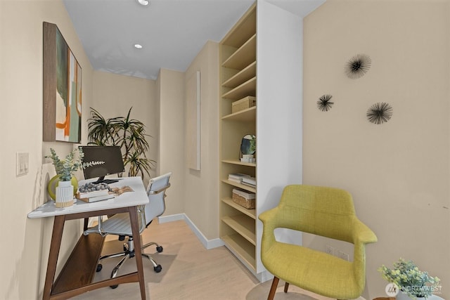 home office with recessed lighting, baseboards, built in shelves, and wood finished floors