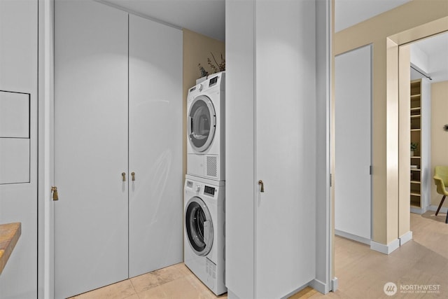 laundry room featuring stacked washer and clothes dryer and laundry area