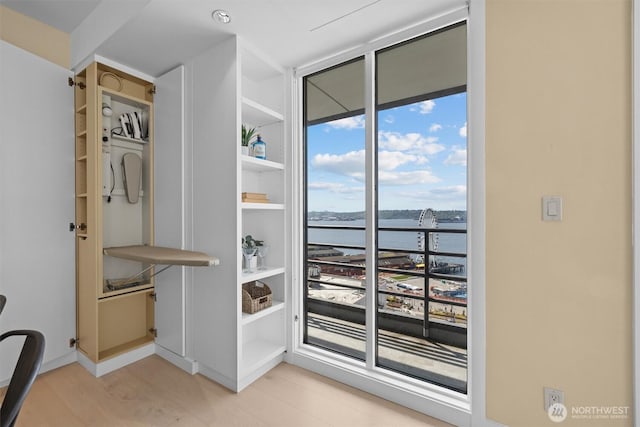 interior space featuring baseboards and a water view