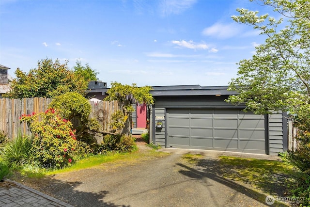 9716 Hunter Point Rd NW, Olympia, WA 98502 - garage featuring dirt driveway and fence
