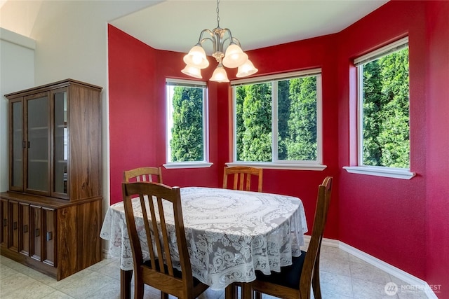 dining room featuring plenty of natural light, a chandelier, and light tile patterned flooring