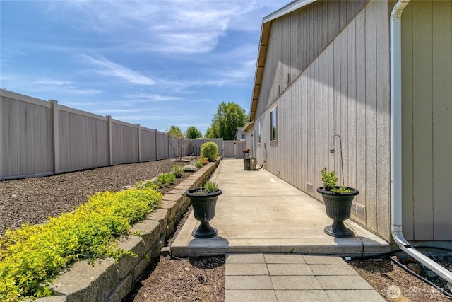 view of home's exterior with a patio area, cooling unit, and a fenced backyard