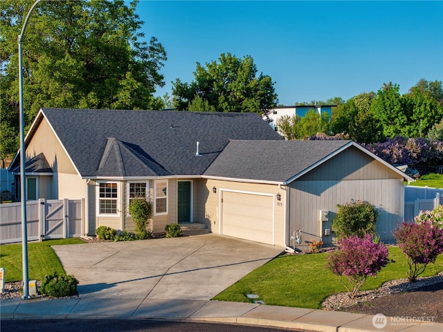 ranch-style home with fence, an attached garage, concrete driveway, a front yard, and a gate