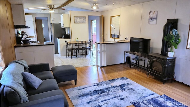 116 Galleon Loop NE, Ocean Shores, WA 98569 - living area featuring light wood-style floors, a ceiling fan, and a wood stove