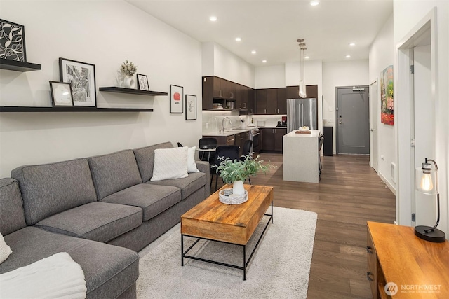 living room featuring dark wood-style flooring and recessed lighting