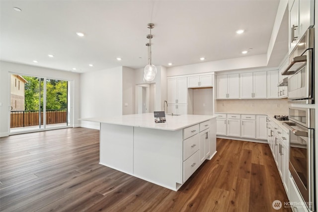 6406 213th Avenue Ct E, Bonney Lake, WA 98391 - kitchen featuring stainless steel oven, dark wood-style floors, an island with sink, white cabinetry, and recessed lighting