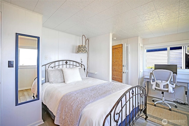 987 Cavalero Rd, Camano Island, WA 98282 - bedroom with wood finished floors, baseboards, and multiple windows