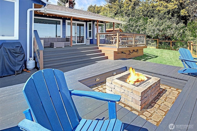 987 Cavalero Rd, Camano Island, WA 98282 - wooden terrace with a grill, a lawn, a fire pit, french doors, and fence