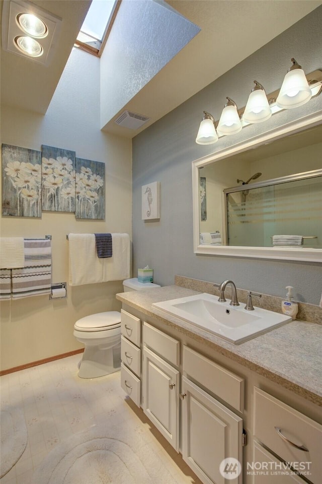 192 Canal Dr NE, Ocean Shores, WA 98569 - full bath with a shower stall, a skylight, toilet, and vanity