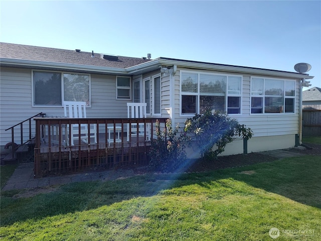 192 Canal Dr NE, Ocean Shores, WA 98569 - back of house featuring a lawn and a deck
