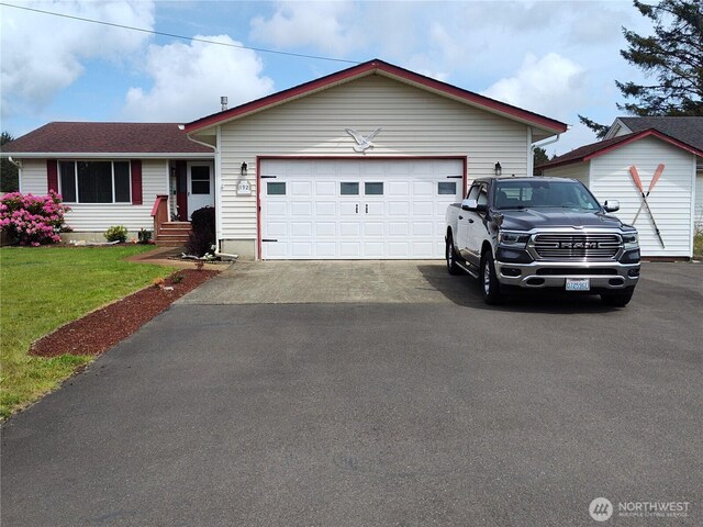 192 Canal Dr NE, Ocean Shores, WA 98569 - ranch-style home featuring driveway, a front yard, and a garage