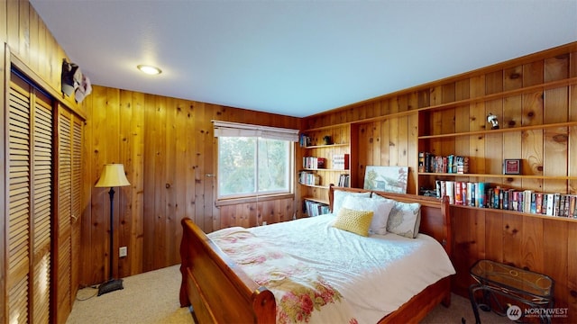 carpeted bedroom with wood walls and a closet